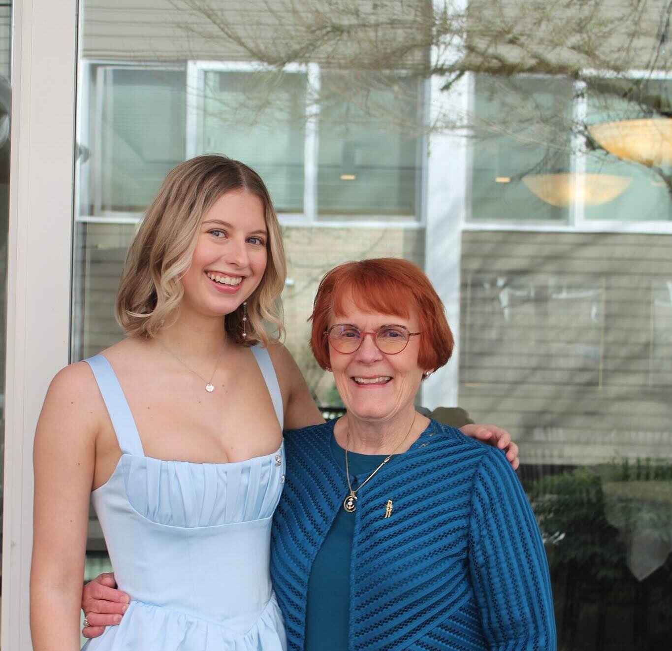 Two women in blue posing for the camera