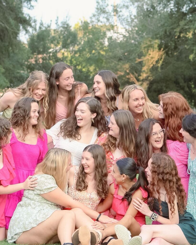 A large group of girls posing for a candid-style photo