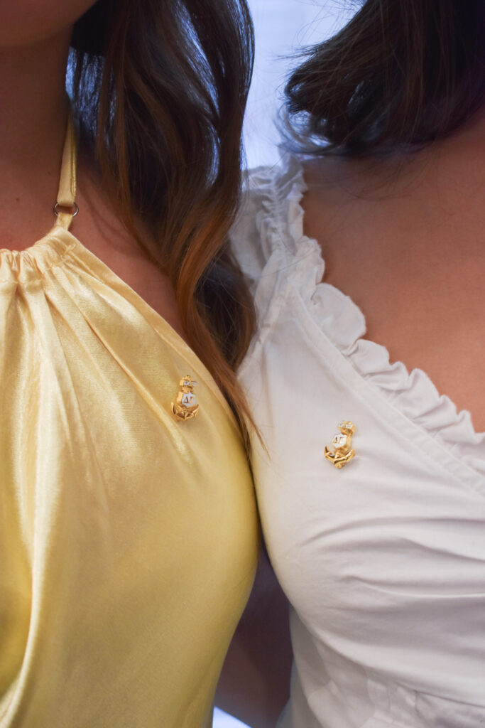 Close up of two girls wearing the Delta Gamma pin