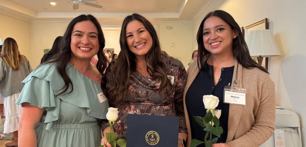 Alumnae women of three with insignia in hand