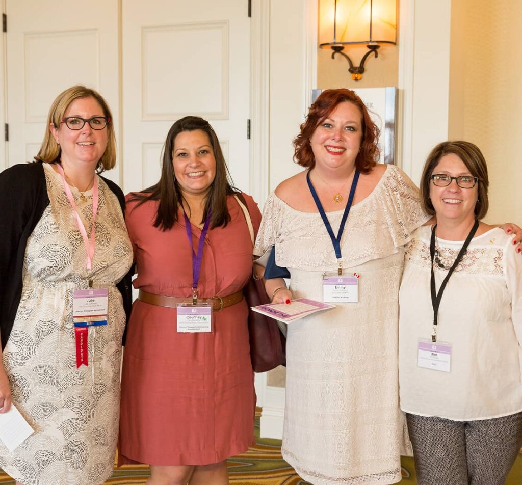 Alumnae members of four with lanyards on