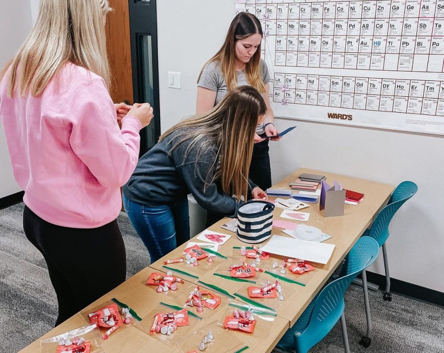Girls putting candy in bags