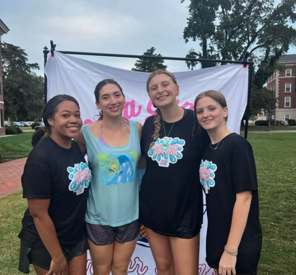 Four girls posing for photo with anchor splash on their t-shirt