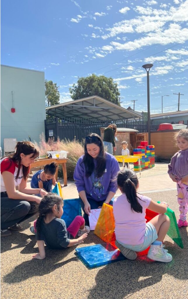 Delta Gamma School initiatives kids playing with Delta Gamma member
