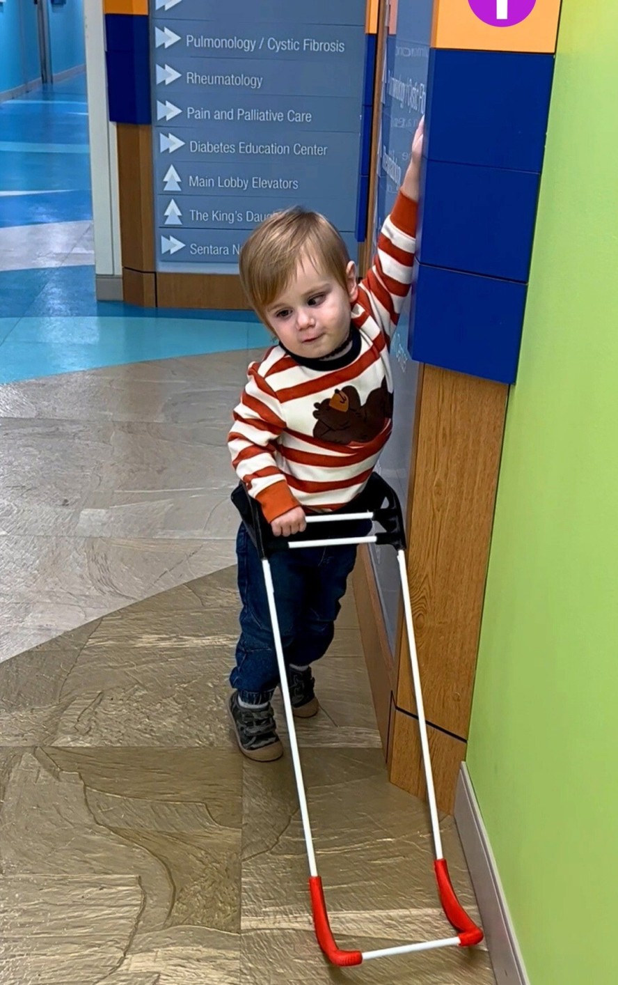 Toddler learning to walk with a guide stick