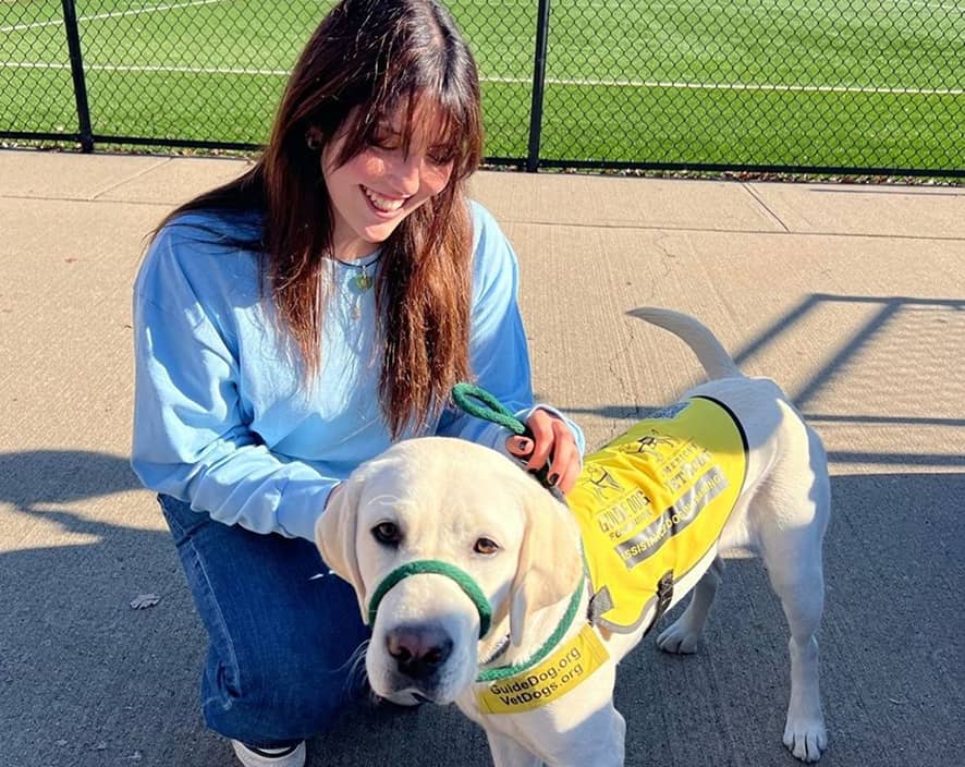 Young girl next to service sight dog