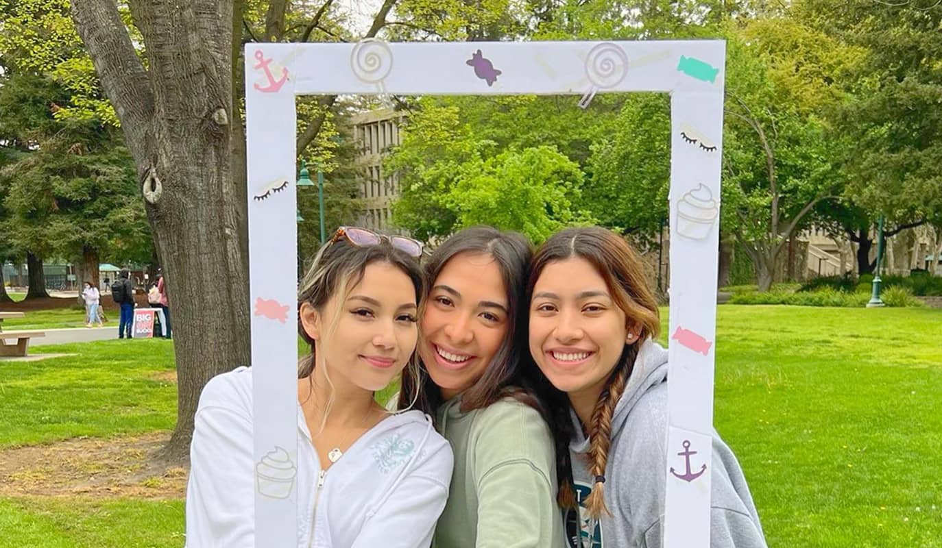DG members posing for photo with a polaroid frame