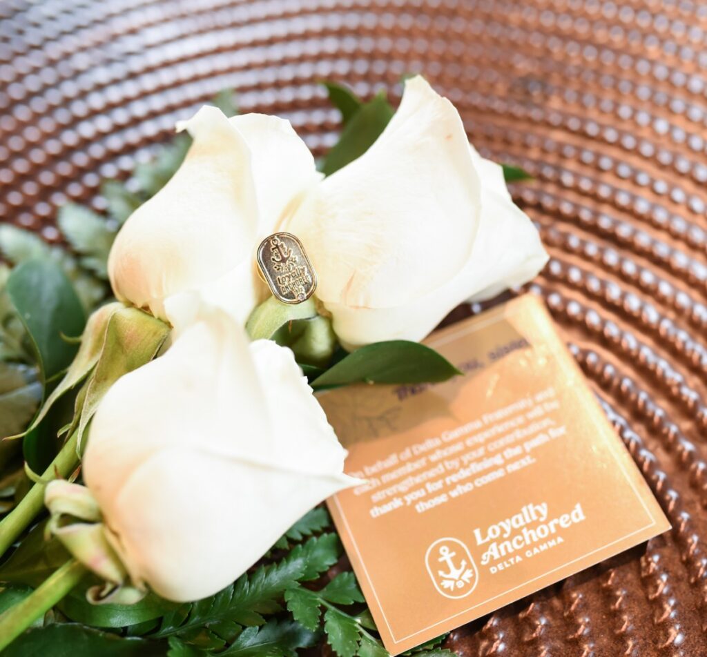 White roses with Loyally Anchored card