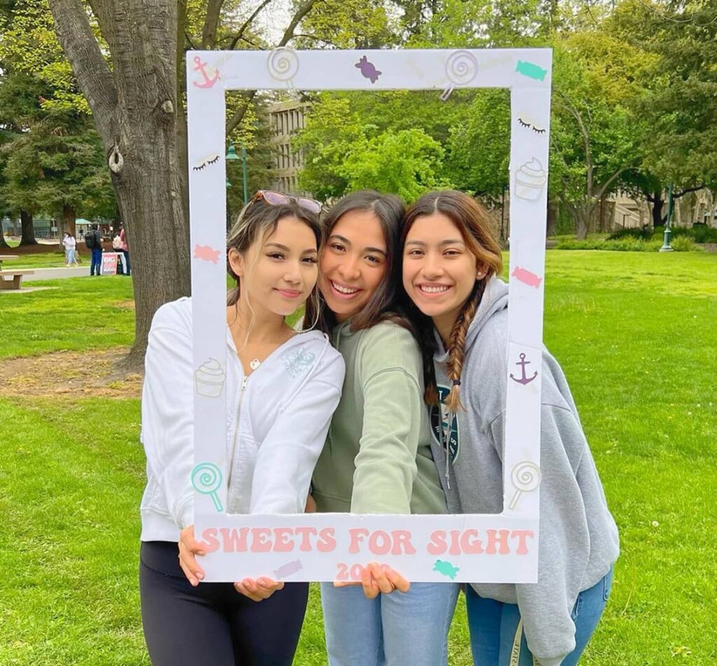 DG members posing for photo with a polaroid frame
