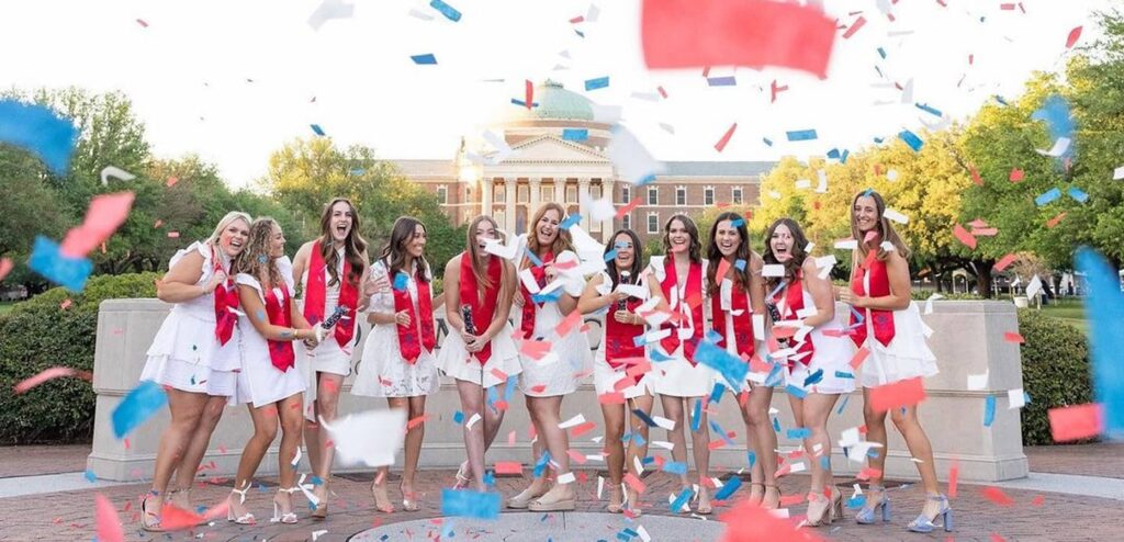 Graduate Delta Gamma's taking grad photos with confetti