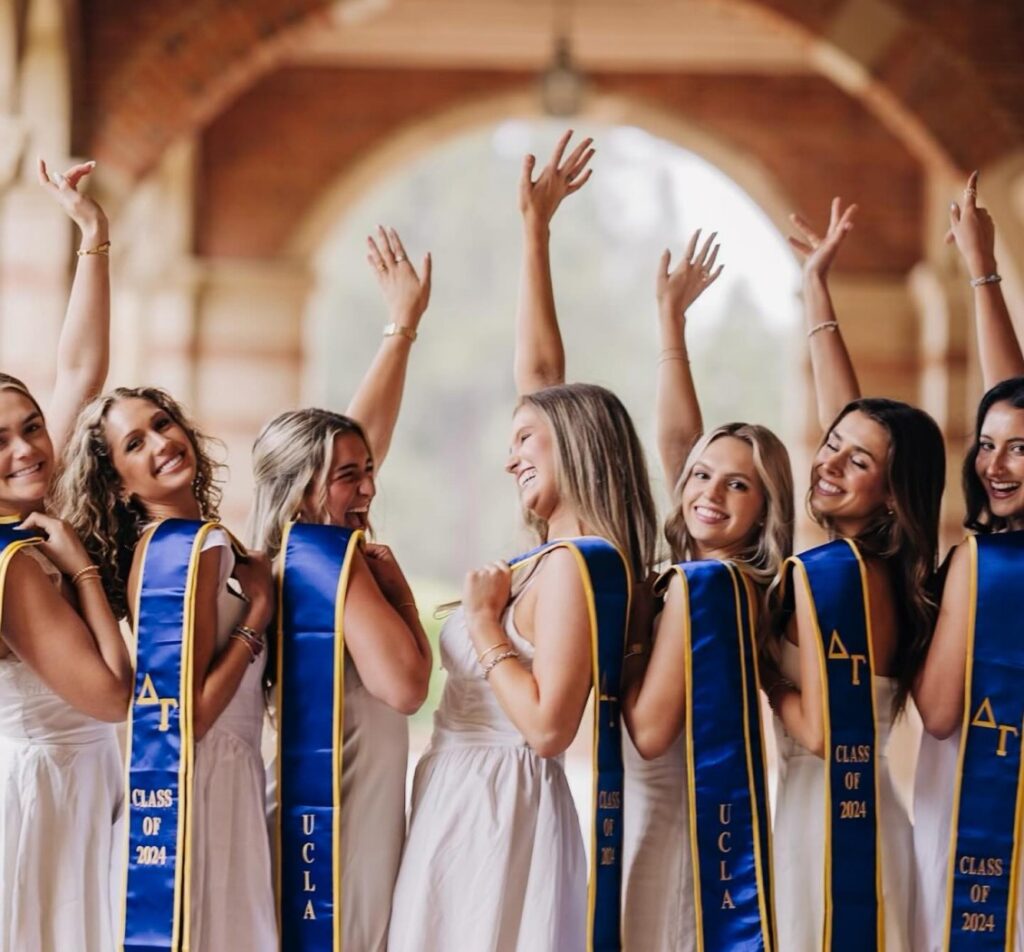 DG Graduates with DG stolls over shoulder