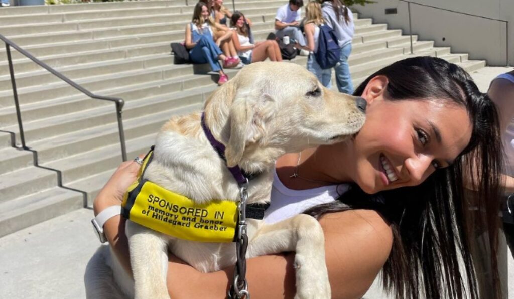 Girl holding guide dog