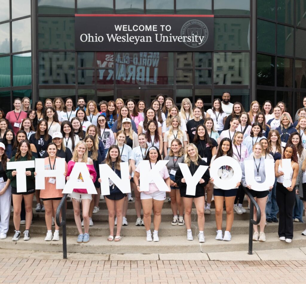 group of DG members with individual letter signs spelling Thank You