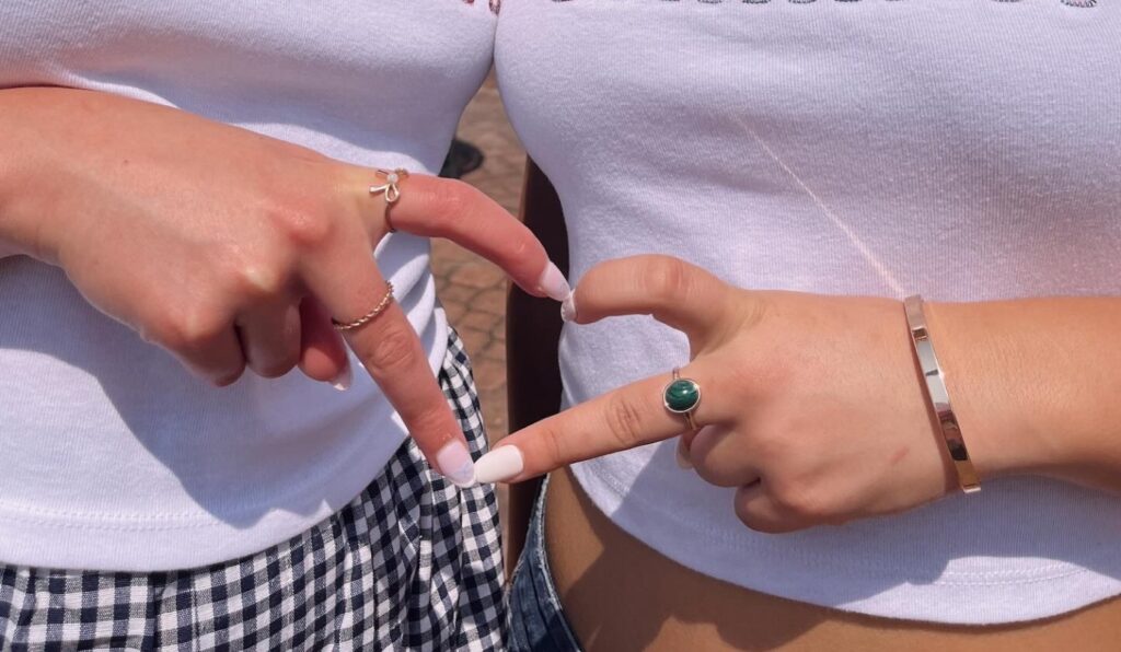 Delta Gamma sisters making a heart symbol with their fingers