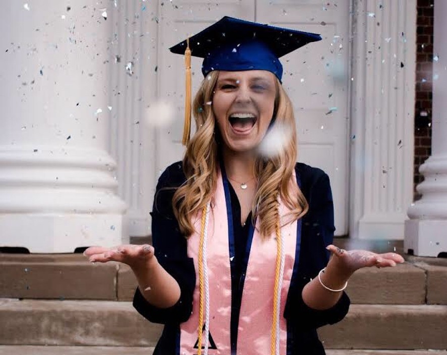 Delta Gamma Graduate throwing confetti