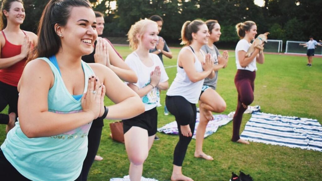 Yoga class doing praying mantis pose