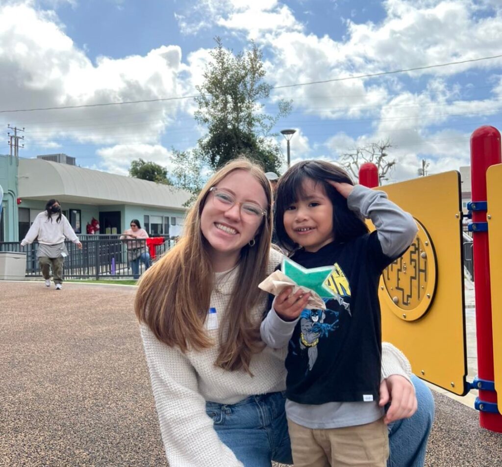 Delta Gamma member next to young child