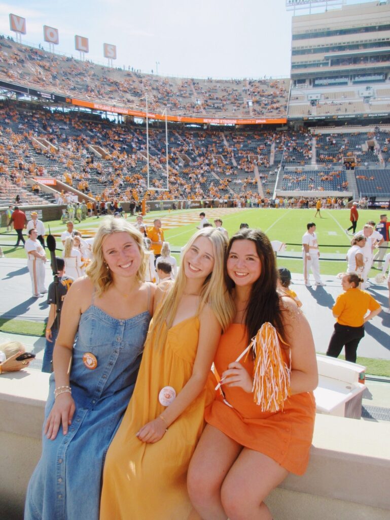 Sisters cheering on a football game.