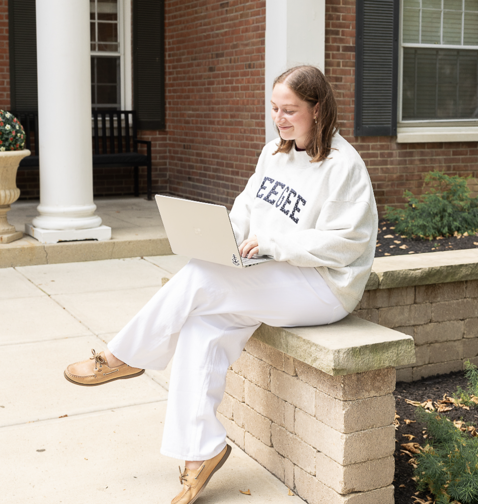 A member of the Delta Gamma CDC team working on her laptop.